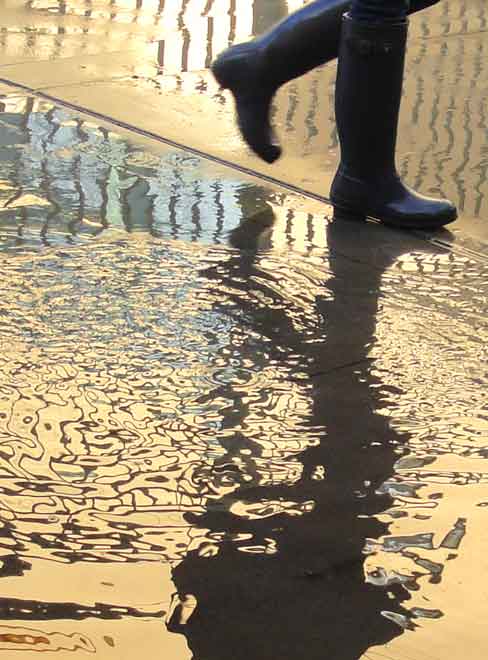  “The Last Time It Really Rained” people ©2007 Maria Sky, All Rights Reserved<br><p>As a student was going to class her rubber rain boots were reflected in the early morning puddle.
