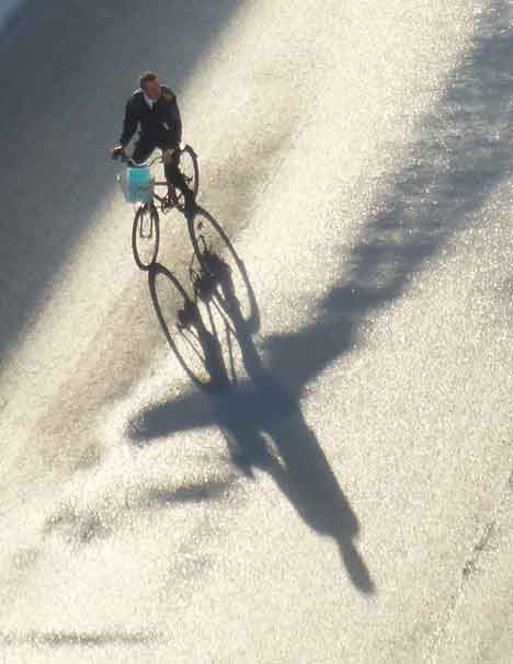  “The Bicyclist” people ©2015 Maria Sky, All Rights Reserved<br><p>From the balcony of the ship a bicyclist was on the pier. A bright blue bag was in the basket and the morning sun cast a beautiful shadow.